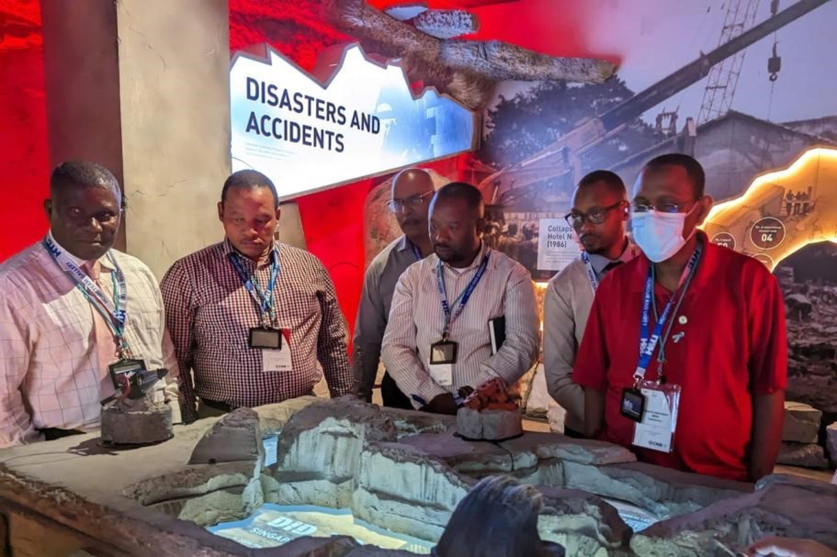 Group views "Disasters and Accidents" exhibit featuring Singapore historical scenes.